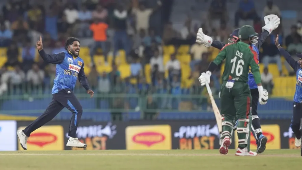 "Cricket players from Sri Lanka and Bangladesh in action during an ODI match at R. Premadasa Stadium, Colombo – crowd in background, day match atmosphere"