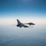 Rafale fighter jet flying at high altitude during a training mission over mountainous terrain.