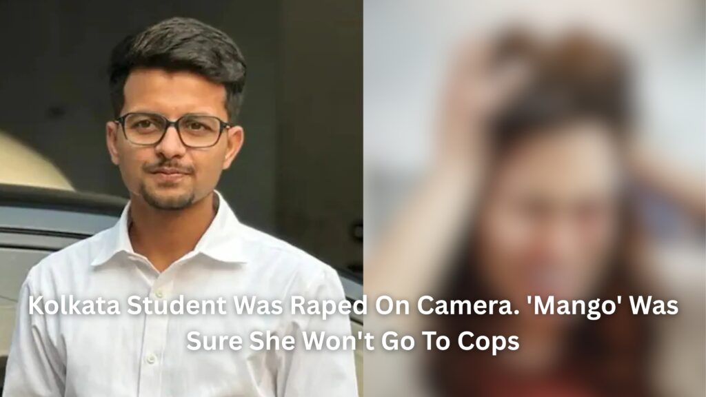 A young man wearing glasses and a red shirt, looking away thoughtfully outdoors with greenery in the background.