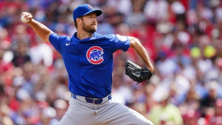 Boston Red Sox pitcher throws a fastball as Chicago Cubs batter prepares to swing during a sunny MLB game at Wrigley Field, 2025 season.