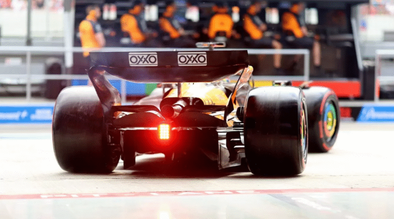 Charles Leclerc leading the Hungarian Grand Prix with McLaren cars closely behind at Hungaroring